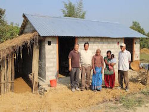 Second widow (old lady in blue skirt) of Kakaura with her completed house